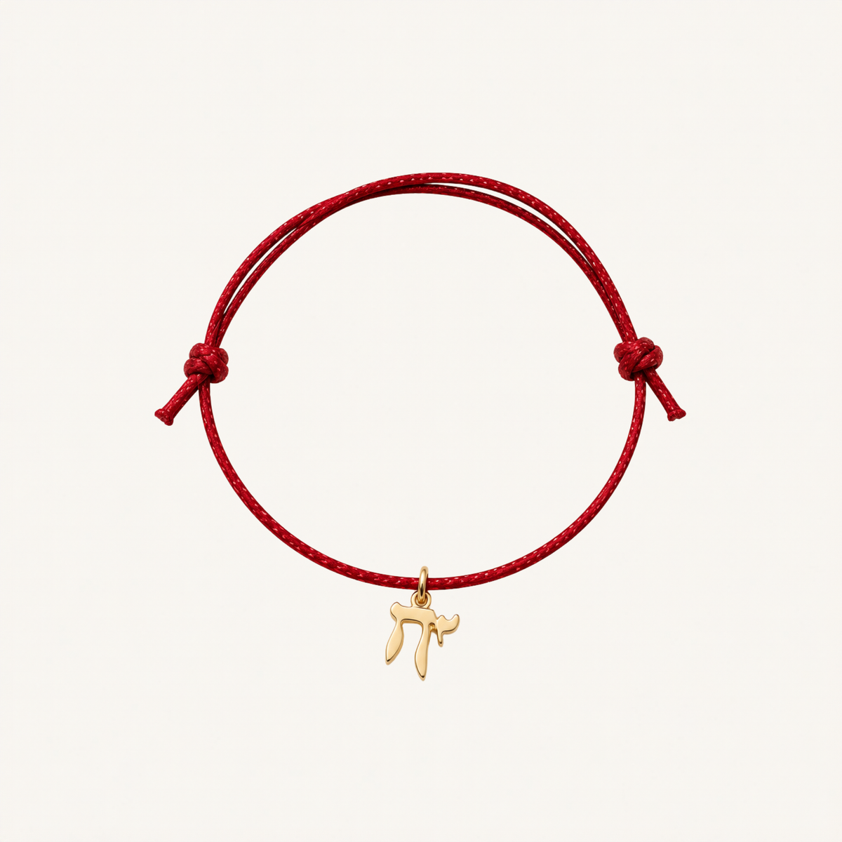 Red adjustable cord bracelet with a gold-tone Chai charm.