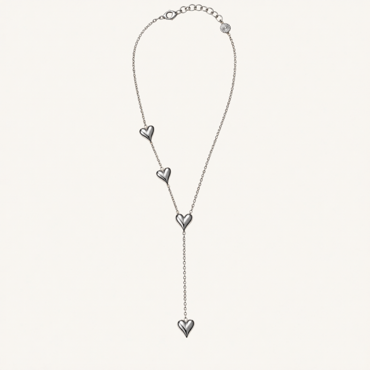 Silver-tone Y-shaped necklace with four heart accents.