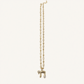 A delicate gold chain necklace featuring a Hebrew letter 'Heh' pendant adorned with small clear stones, displayed against a solid off-white background.