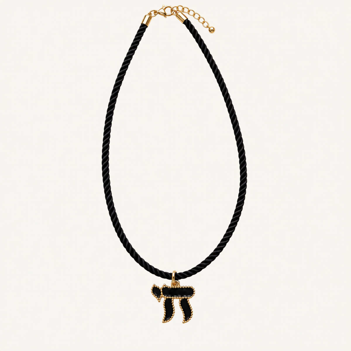 Twisted black cord necklace with a black and gold-tone Chai pendant.