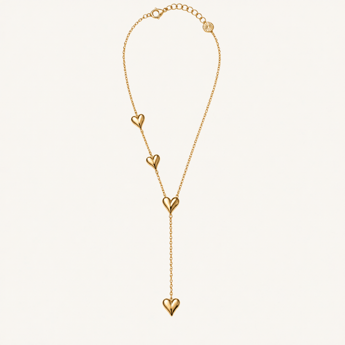 Gold-tone Y-shaped necklace with four heart accents.