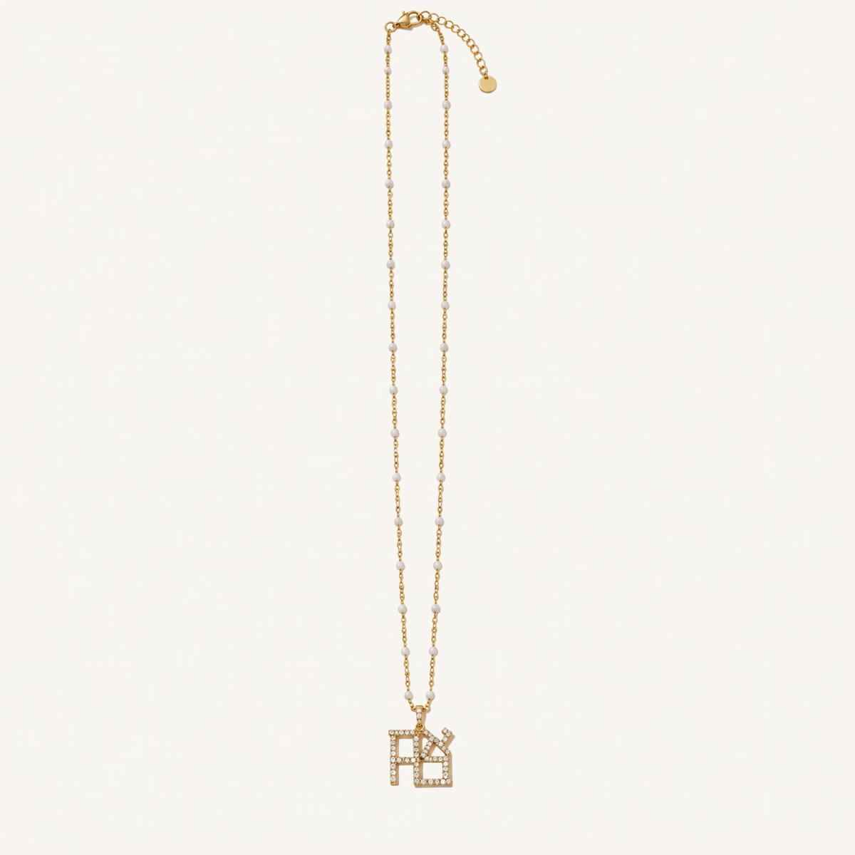 Gold-tone necklace with white bead accents and a Hebrew Ahava pendant.
