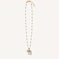 Gold-tone necklace with dark blue bead accents and a dark blue Chai pendant.