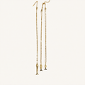 Three long gold-toned chain necklaces with dangling fish-shaped pendants, displayed against a plain off-white background.