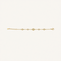 A delicate gold chain bracelet featuring a central pavé diamond heart motif and smaller diamond accents, displayed horizontally on a clean off-white background.