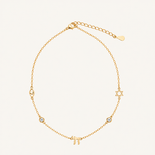 A delicate gold chain necklace featuring Hebrew letter charms, including a Pi symbol and a Star of David, with a small clear stone accent, displayed on a light cream background.