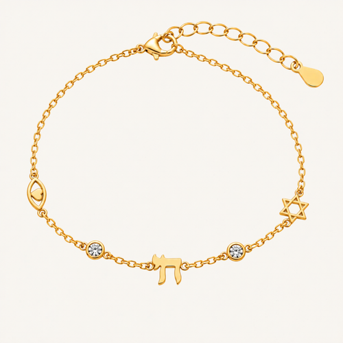 A gold chain bracelet featuring Hebrew letter charms, a Star of David, a crescent moon, and two small bezel-set clear stones, displayed on a light cream background.